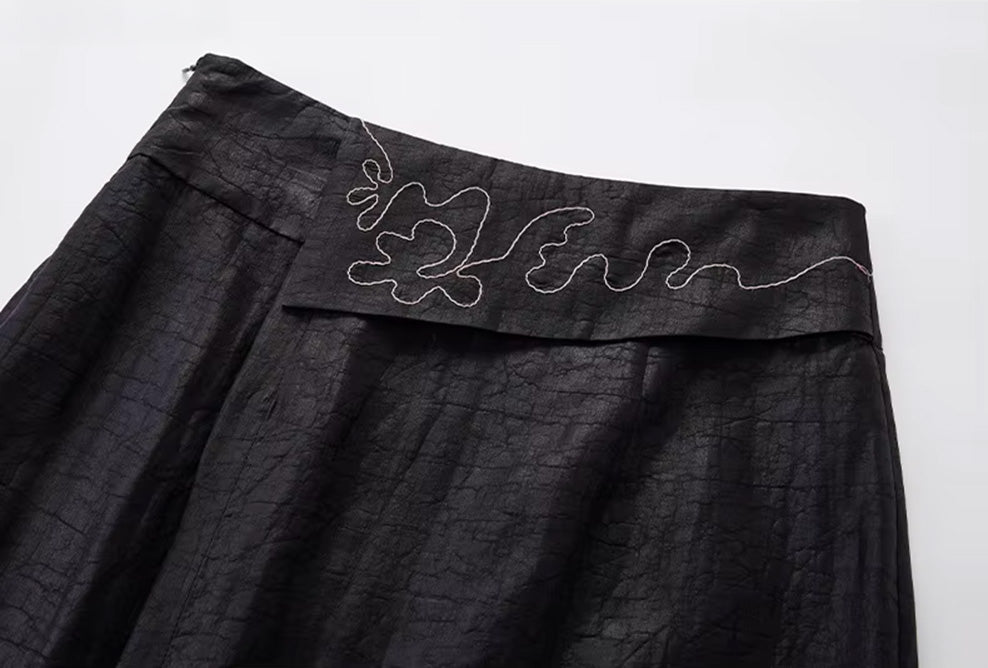 Close-up of the front construction showing the structured waist yoke and  the front decorative placket — From Borcelleclothes.