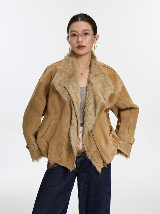 Model wearing the Candle Wheat goatskin jacket with hands resting at the hips, showing soft suede texture and elasticized hem — From Borcelleclothes.