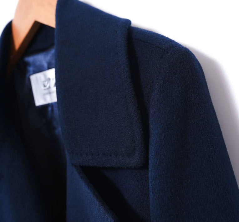 The lapel, shoulder, and sleeve on the Women's 7/8 Cashmere Blend Coat in Deep Cove, emphasizing its sharp tailoring and refined design. From Borcelleclothes.