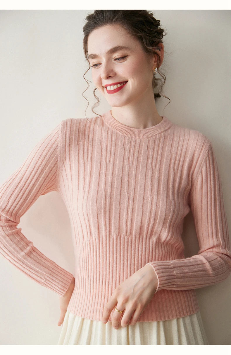 Smiling model in Pastel Pink cashmere sweater resting hand on hip — From Borcelleclothes.