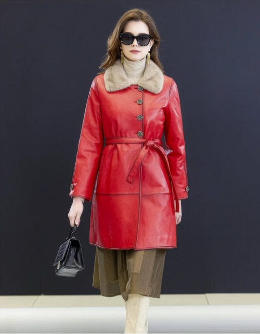 Model in red asymmetrical sheepskin coat walking forward. Mink collar and sculpted silhouette visible in motion — From Borcelleclothes.
