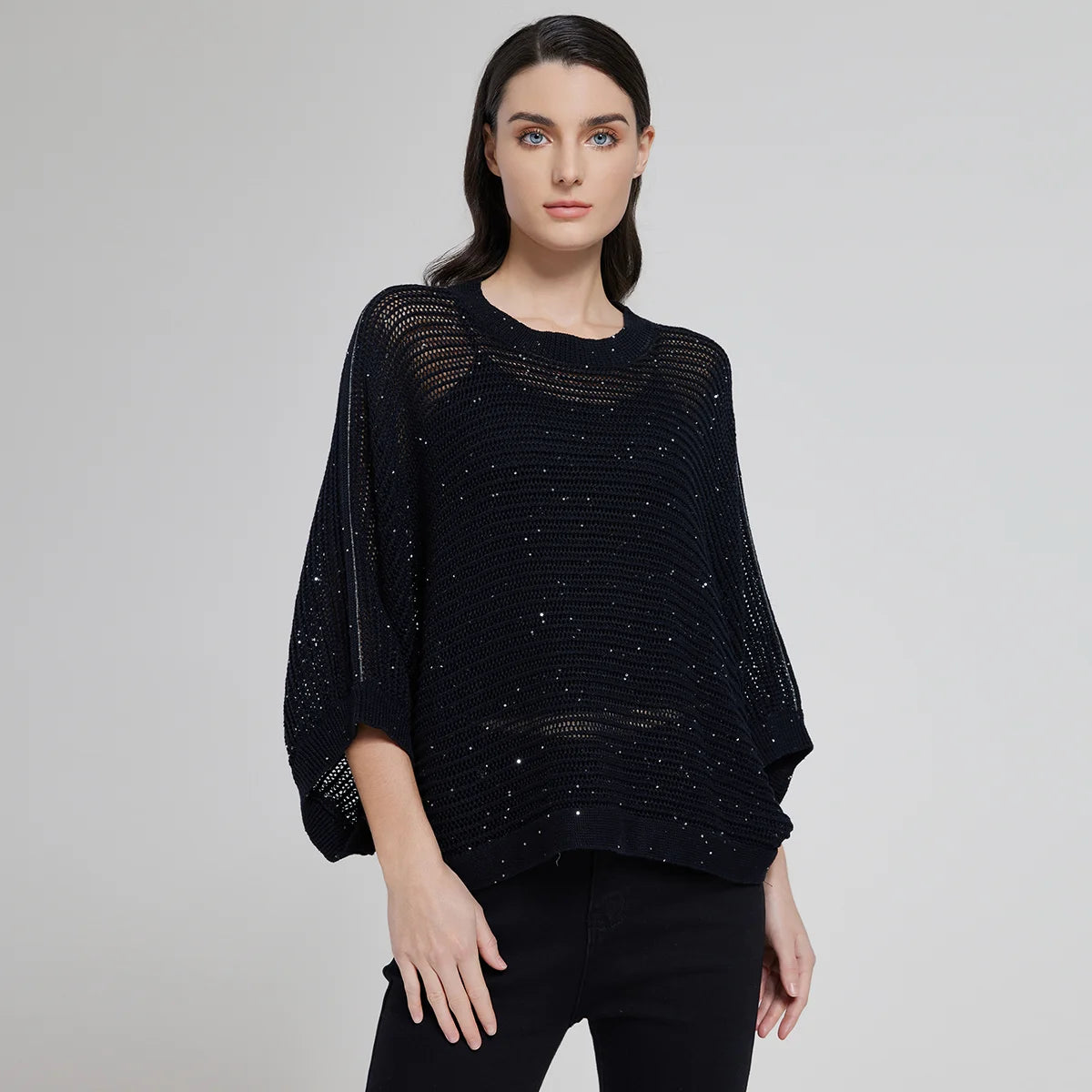 Women's batwing linen mesh top in Onyx, featuring openwork knit and wide ribbed trims, styled with soft natural light. From Borcelleclothes.