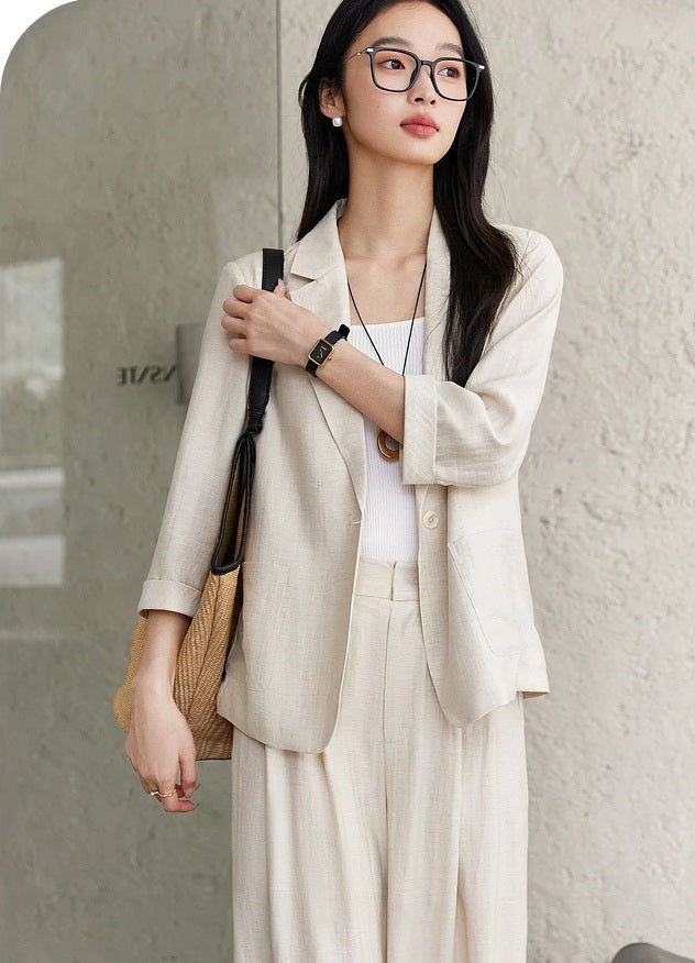 Model adjusting the strap of a shoulder bag while wearing the Bon Jour two-piece set. From Borcelleclothes.