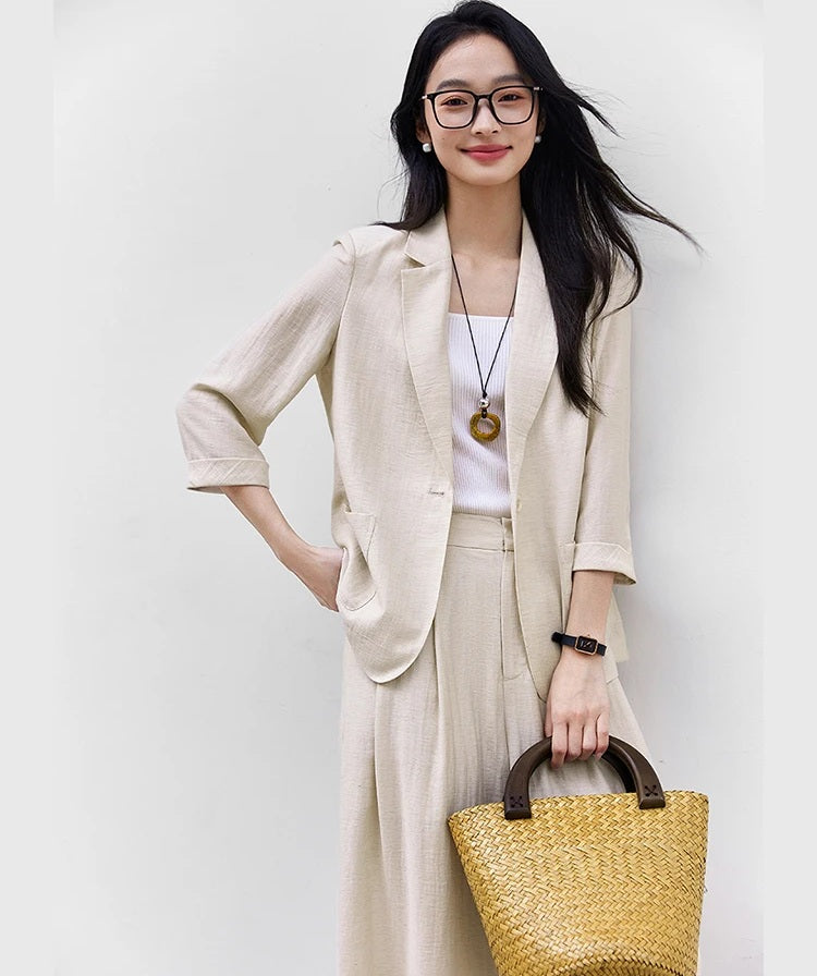 Model in the Bon Jour two-piece set with one hand at the hip, highlighting relaxed tailoring and posture. From Borcelleclothes.