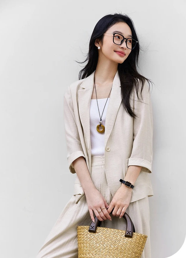 Model wearing the Bon Jour two-piece set while holding a straw bag, styled for relaxed urban simplicity. From Borcelleclothes.
