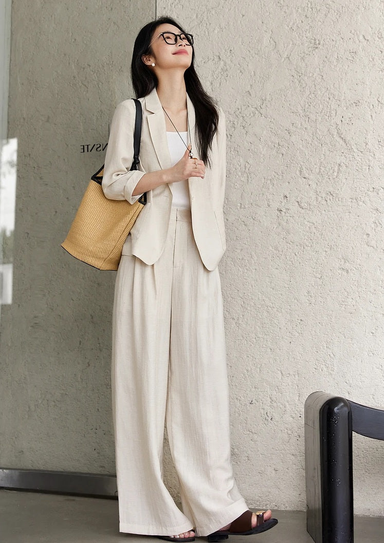 Smiling model looking upward while wearing the Bon Jour two-piece set in a soft undefined shade. From Borcelleclothes.