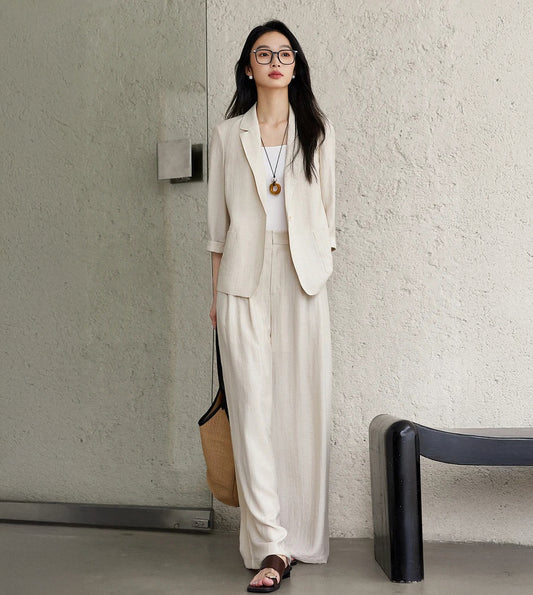 Women's two-piece set in an undefined neutral shade Bon Jour, featuring a relaxed silhouette and minimalist tailoring that reflect quiet urban elegance. From Borcelleclothes.