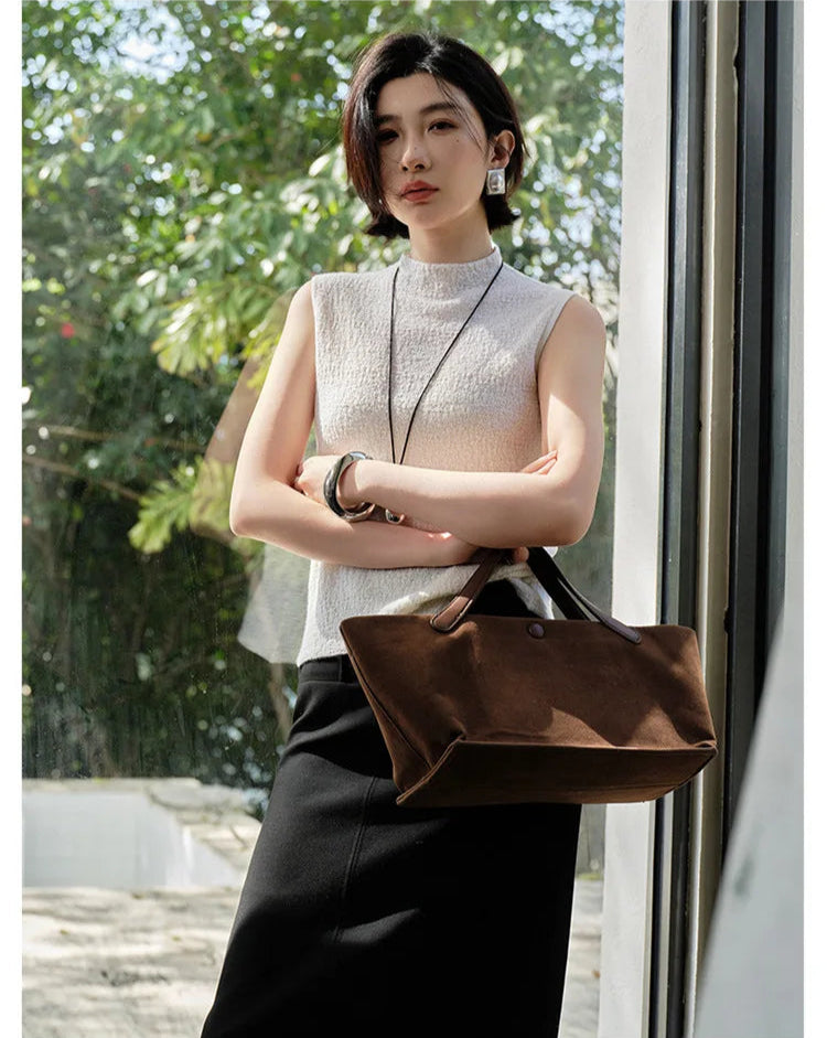 Model in Pearl Bush bouclé cashmere top with arms crossed, revealing the soft slim silhouette — From Borcelleclothes.