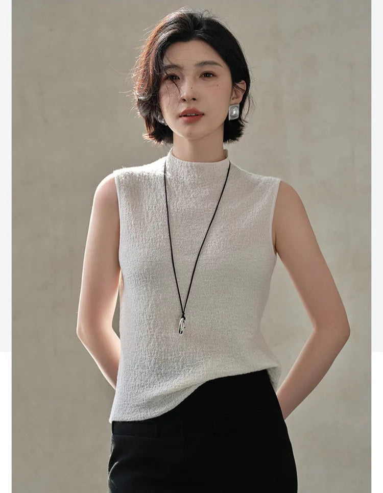 Slim-fitting bouclé cashmere top in Pearl Bush, worn by model with hands behind back — From Borcelleclothes.