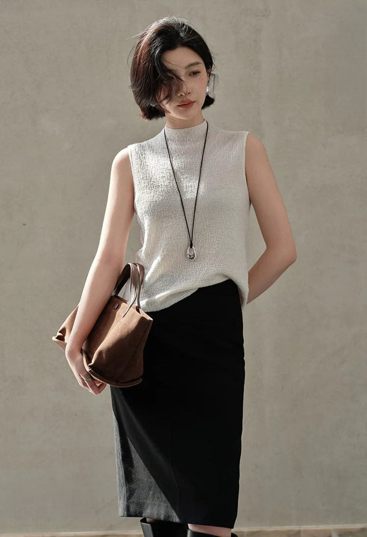 Slim-fitting bouclé cashmere top in Pearl Bush, model styled with a brown bag — From Borcelleclothes.