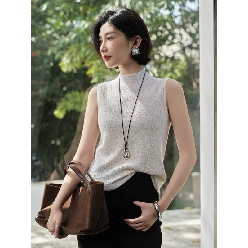 Model, wearing the Pearl Bush bouclé cashmere top, looking to the side — From Borcelleclothes.