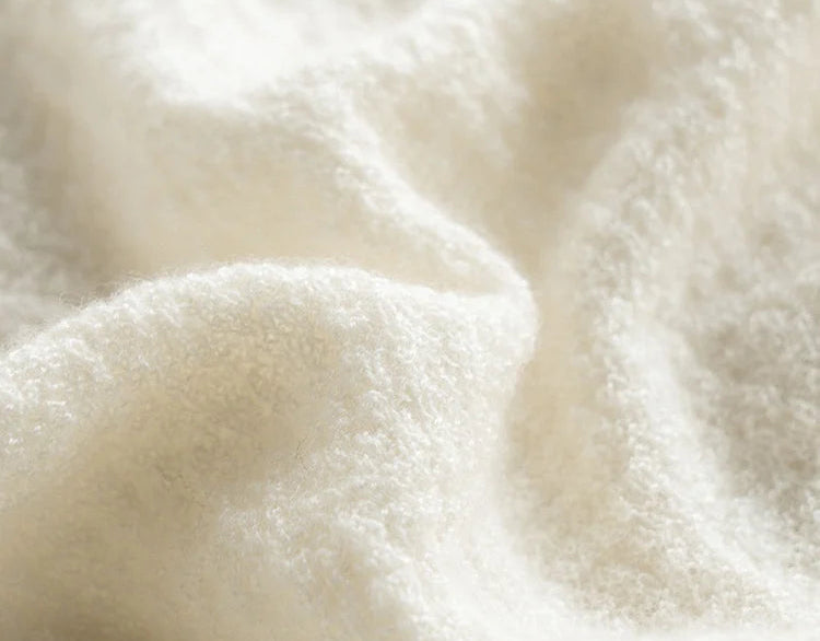 Close texture view of the bouclé knit in Pearl Bush, made from 100% cashmere — From Borcelleclothes.