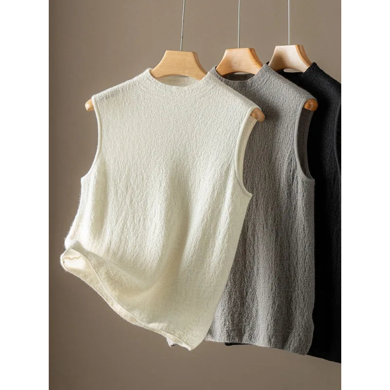 Bouclé cashmere tops in Pearl Bush, Silver Sand, and Onyx displayed on hangers — From Borcelleclothes.