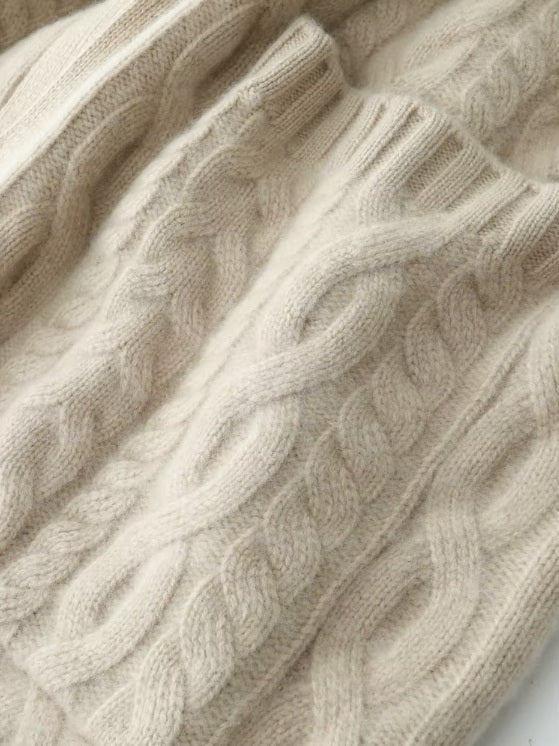 The large front pocket with ribbed detailing on the women's Cable-Knit Cashmere Wool Coat in Pearl Bush, highlighting its functional and modern aesthetic, Borcelleclothes.