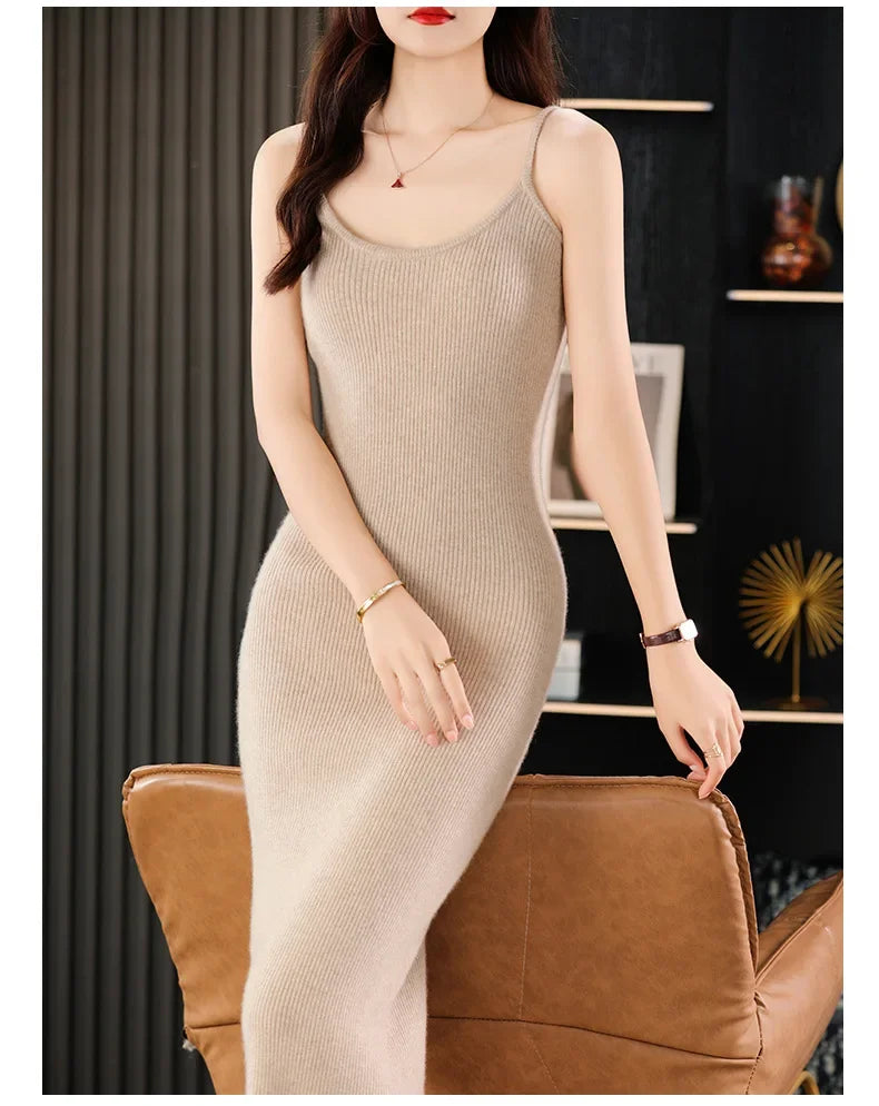 Woman standing in front of an armchair in a Vanilla wool camisole dress, the ribbed texture bringing subtle structure to the silhouette. From Borcelleclothes.