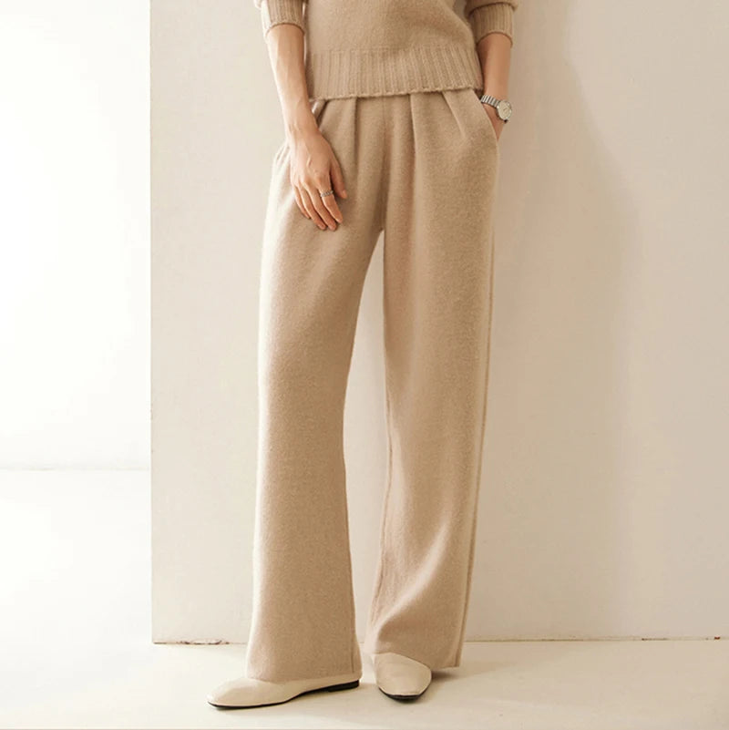 Model with hand in pocket wearing Pale Taupe pleated cashmere trousers — From Borcelleclothes.