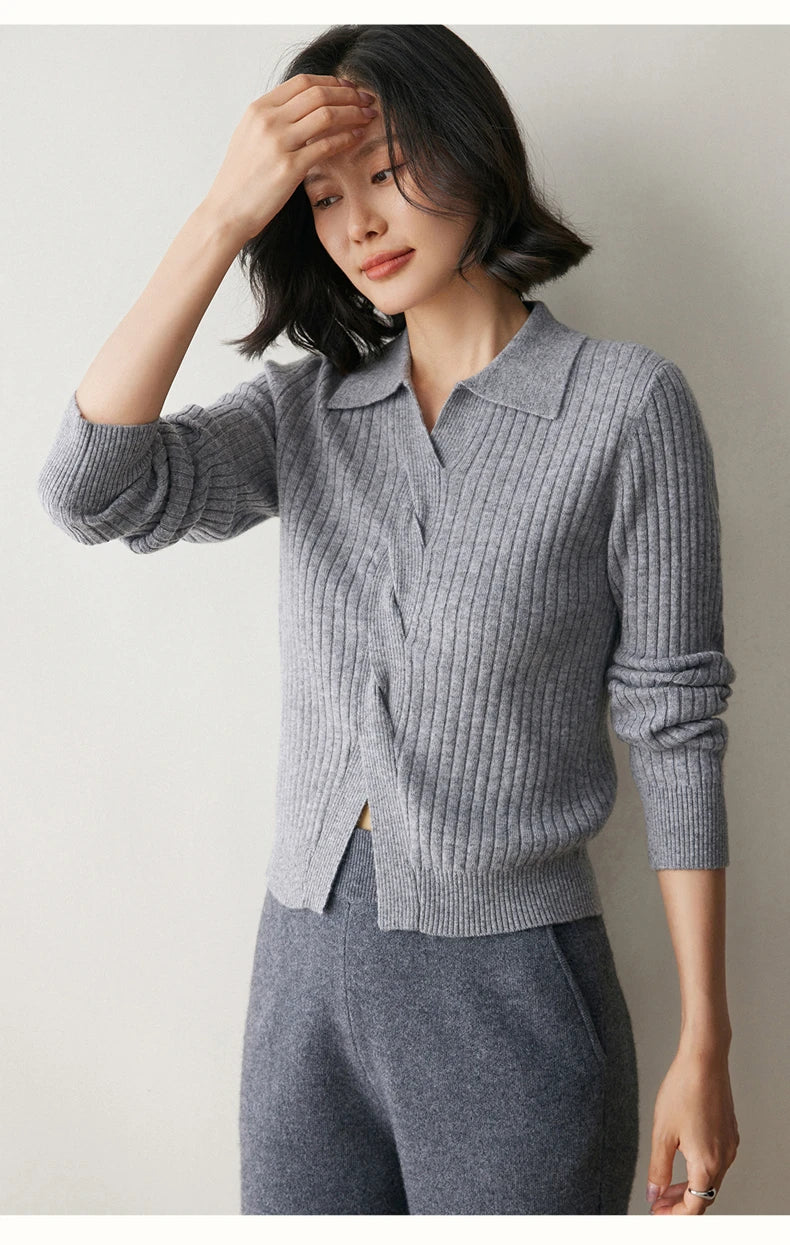 Model adjusting hair in women’s cashmere rib sweater in Oslo Grey — From Borcelleclothes.