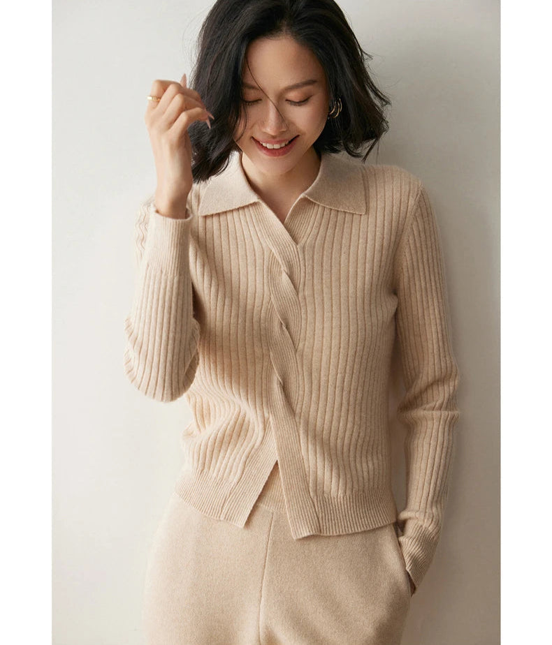 Model adjusting hair in women’s cashmere rib sweater in Pale Taupe — From Borcelleclothes.
