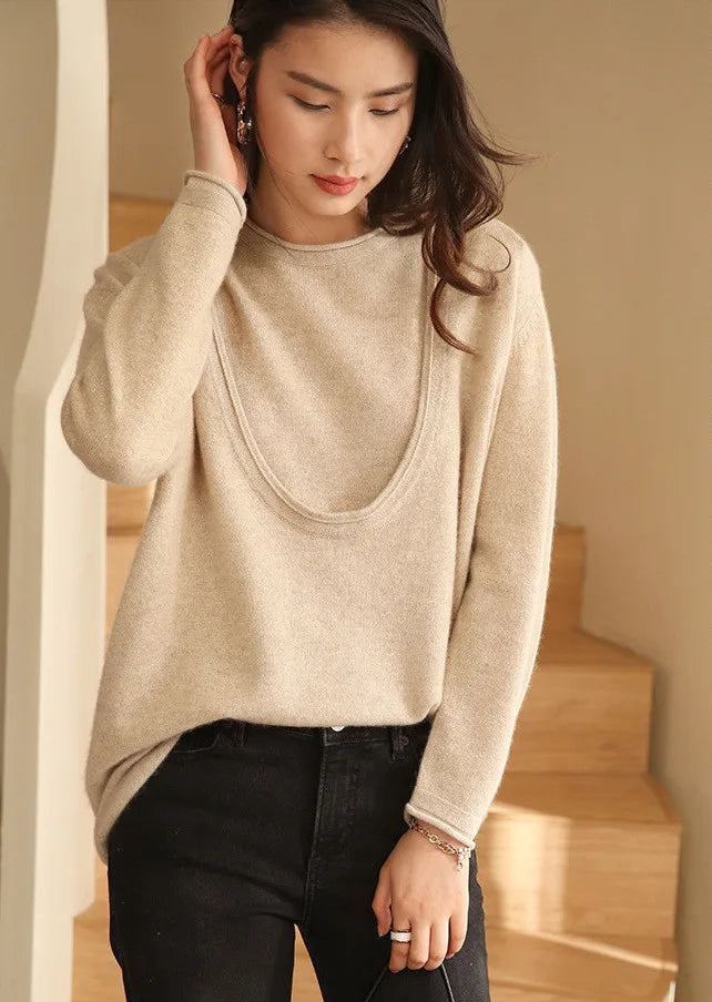 Model in Foggy Grey cashmere set adjusting her hair, neckline visible — From Borcelleclothes.