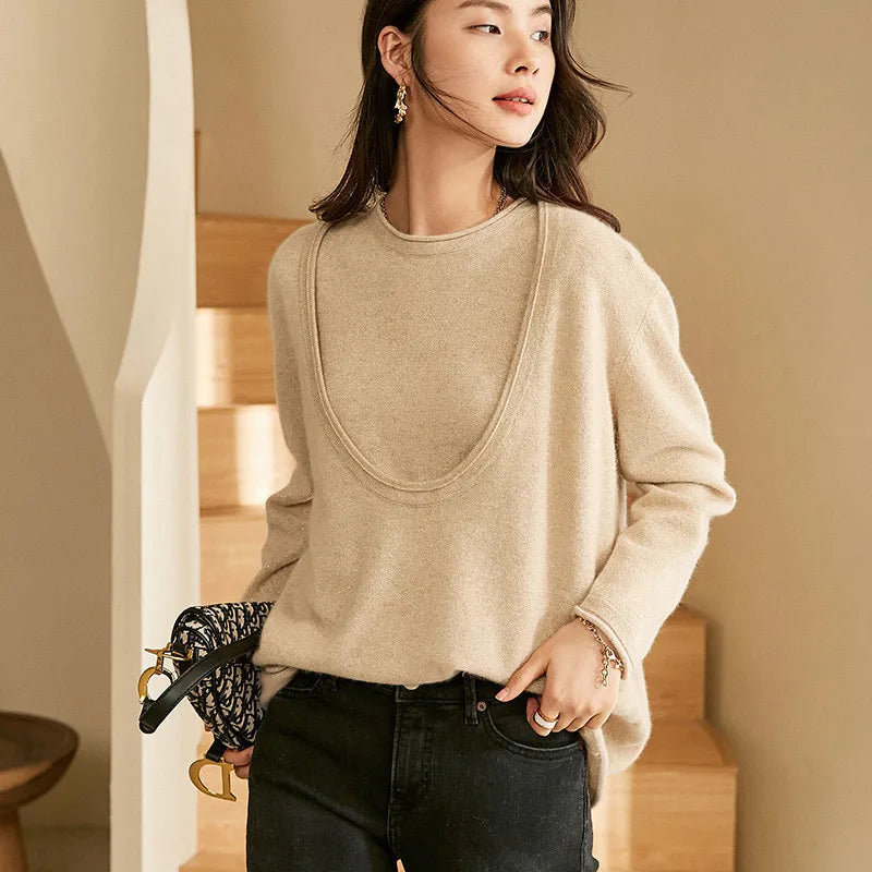 Model wearing Foggy Grey cashmere set with deep neckline, turned slightly to the side — From Borcelleclothes.