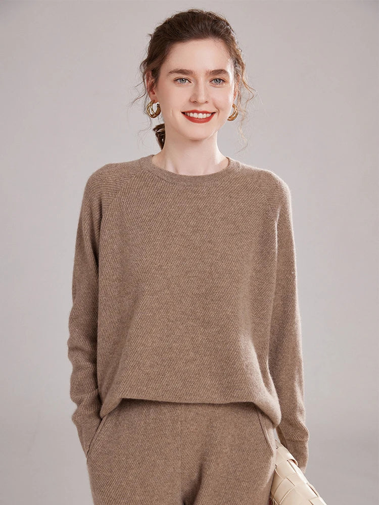 Model holding a bag while wearing the Pastel Brown cashmere set – From Borcelleclothes.