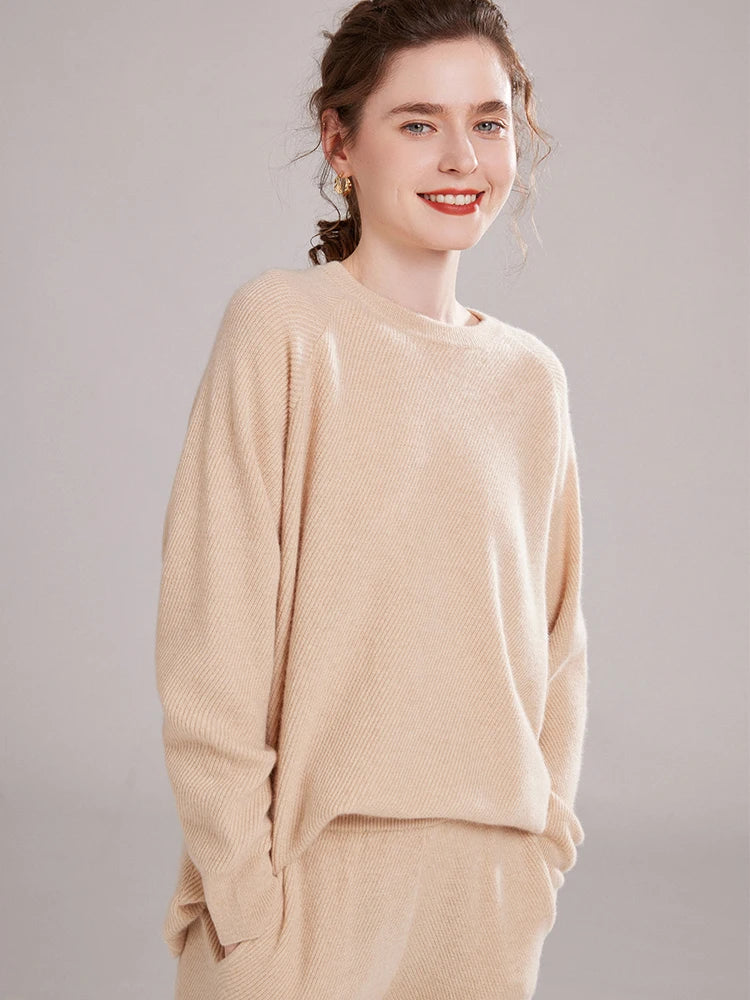 Model in Vanilla diagonal-knit cashmere set with hands in pockets – From Borcelleclothes.