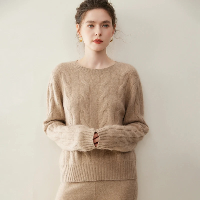 Women's cashmere set with two-strand cables in Pale Taupe, model hiding hands in sweater cuffs — From Borcelleclothes.