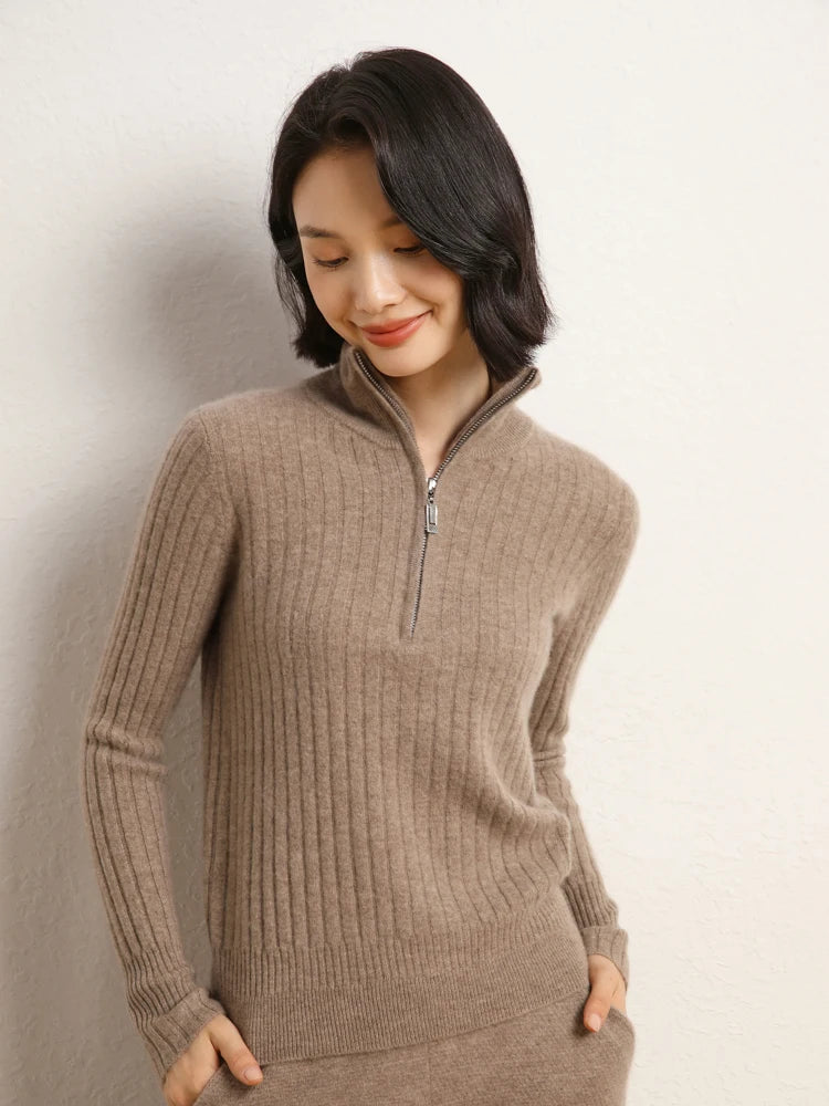 Model slightly bent, head lowered, wearing cashmere sweater in shifting ribs, Pale Taupe — From Borcelleclothes.