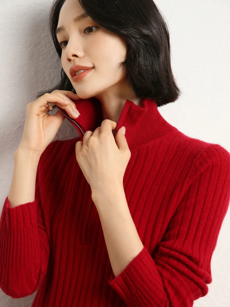 Model touching collar with both hands in cashmere sweater in shifting ribs, Sangria — From Borcelleclothes.