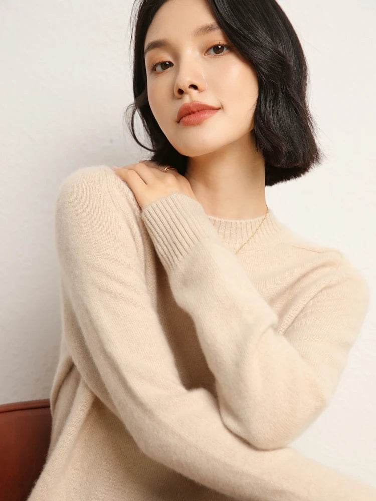 Woman in Almond cashmere sweater touching opposite shoulder – From Borcelleclothes.