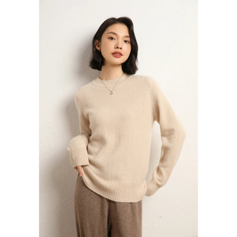 Women’s slim-fit sweater in 100% Alashan cashmere with saddle sleeves, ribbed crew neck, and 2x2 ribbed cuffs and hem, shown in Almond color — From Borcelleclothes.