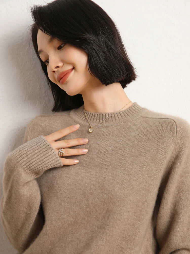 Woman in Pale Taupe cashmere sweater resting hand near chest – From Borcelleclothes.