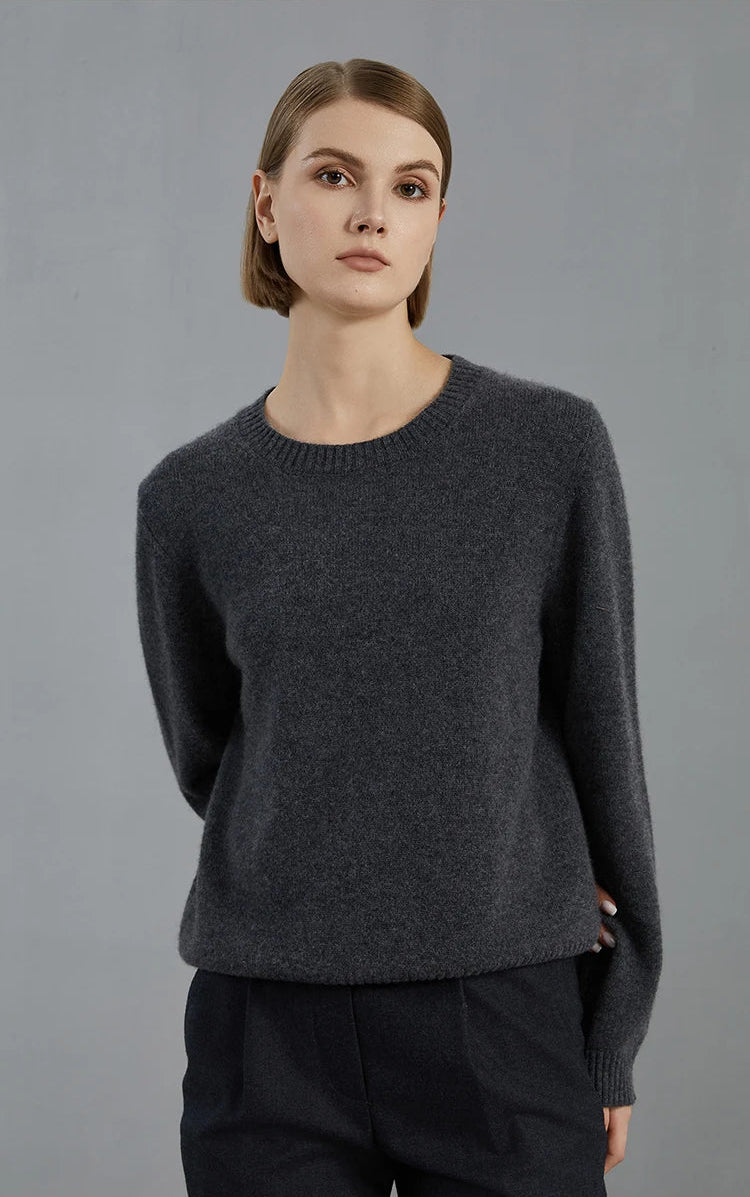 Model’s hand behind the back, drawing attention to sleeve construction in the Baltic Sea sweater — From Borcelleclothes.