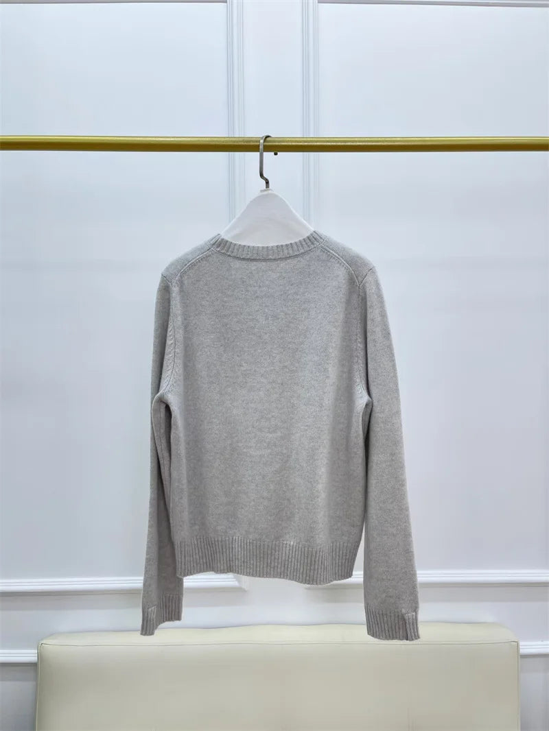 Women’s slim-fit cashmere sweater in Silver Sand, with ribbed cuffs featuring subtle metal accents — From Borcelleclothes.