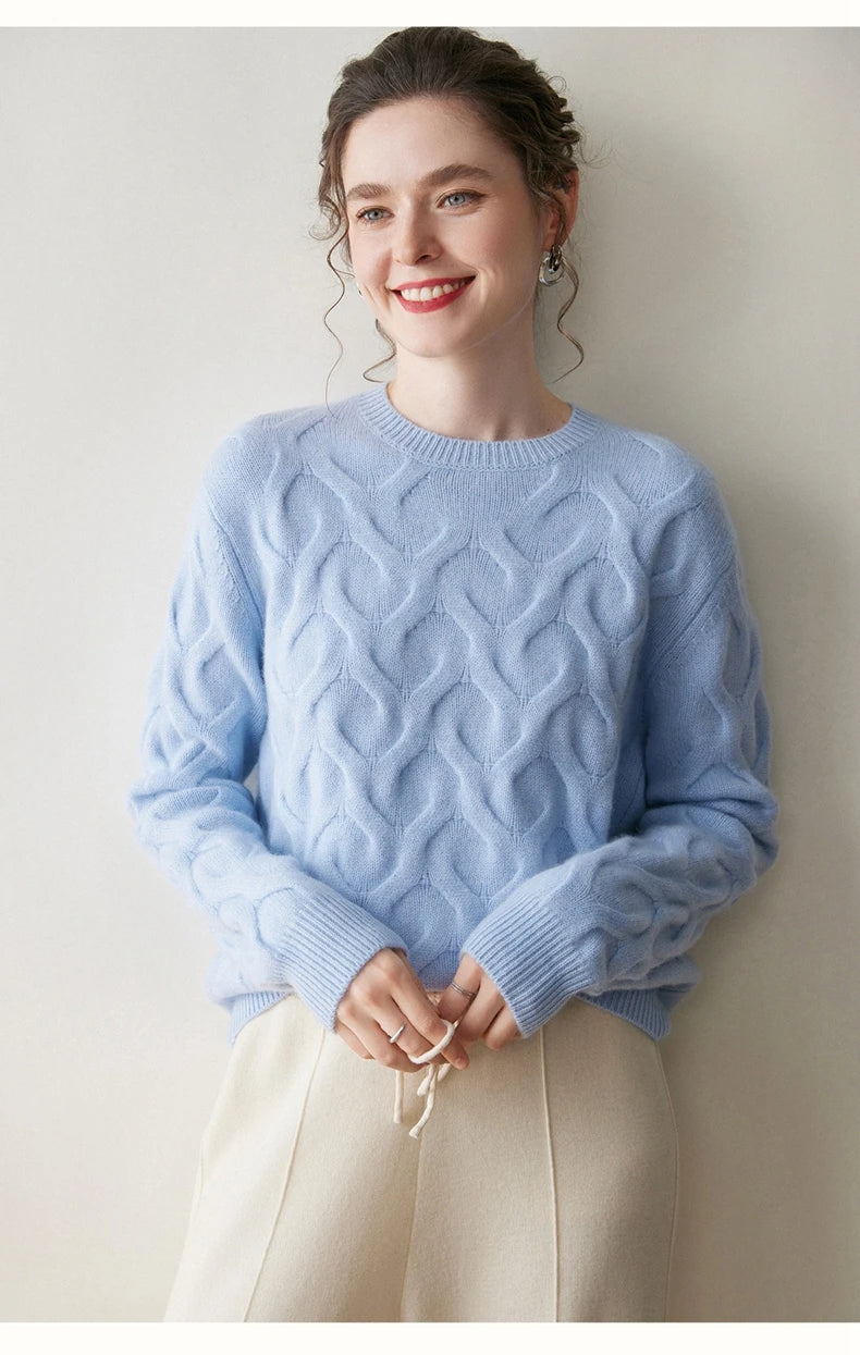 Model holding the cord of her pants while wearing Forget Me Not cashmere sweater with airy heart relief — From Borcelleclothes.