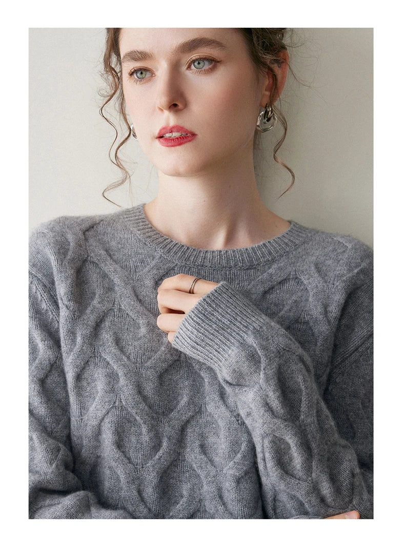Model in Oslo Grey cashmere sweater with hand resting on chest, highlighting the illusion of hearts — From Borcelleclothes.