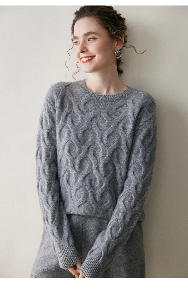 Model gently touching the cuff of the Oslo Grey cashmere sweater, revealing 1x1 rib texture — From Borcelleclothes.