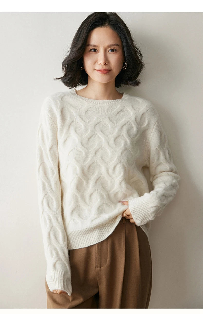 Model lifting the bottom hem slightly of the Pearl Bush cashmere sweater, revealing soft ribbed finish — From Borcelleclothes.