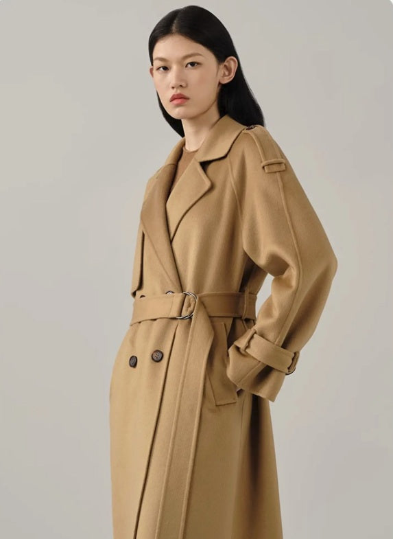 Model in the women's cashmere trench coat in Light Taupe, turned to the side, emphasizing the soft cashmere texture and tailored silhouette. From Borcelleclothes.