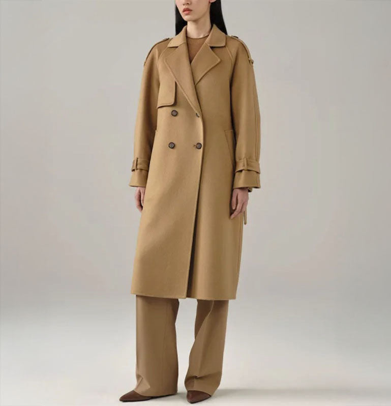 Women's Tibetan Cashmere Trench Coat in Light Taupe, featuring a luxurious military-inspired design with a single storm flap, adjustable sleeve tabs, and a belted waist for a refined, tailored silhouette. From Borcelleclothes.
