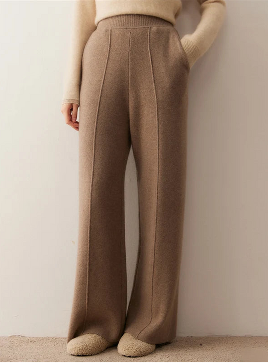 Model wearing pastel brown cashmere trousers with tuck detail, hand in pocket — From Borcelleclothes.