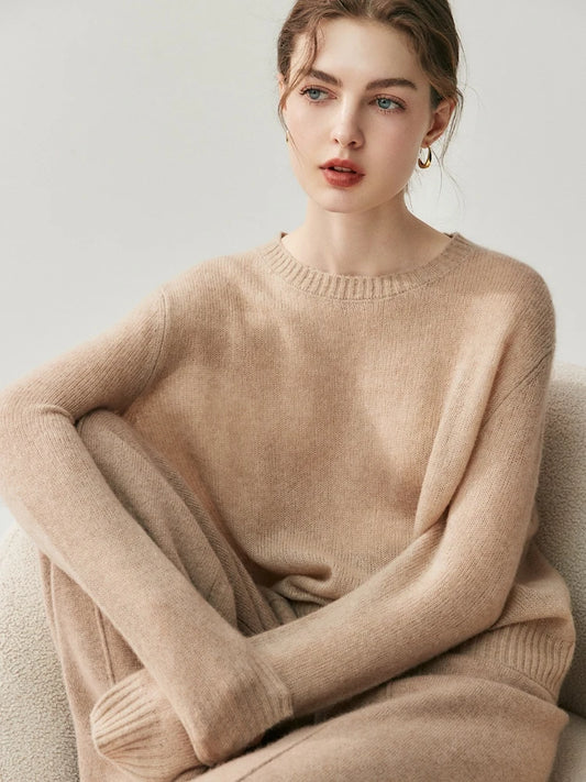 Model sitting on the floor wearing Sandrift pure Alashan cashmere straight-leg trousers with front knitted tucks — From Borcelleclothes.