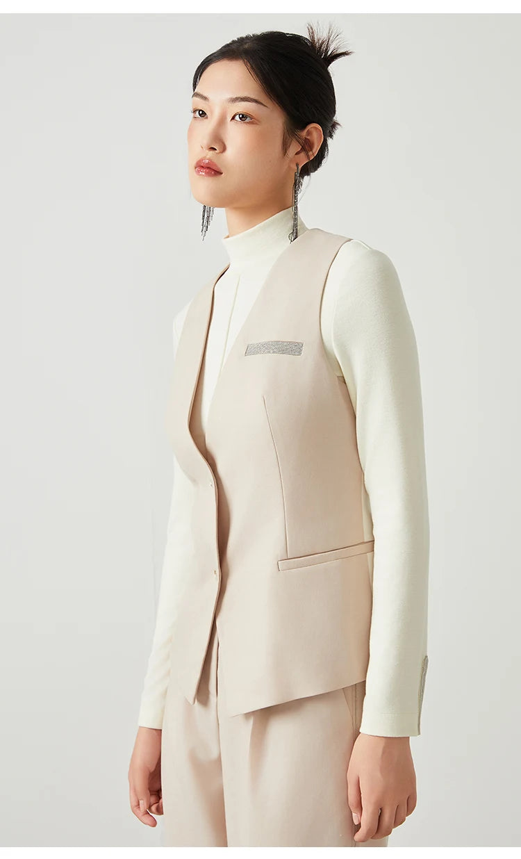 Woman wearing the Classical V-neckline vest in Silver Pink, turned slightly to the side — From Borcelleclothes.