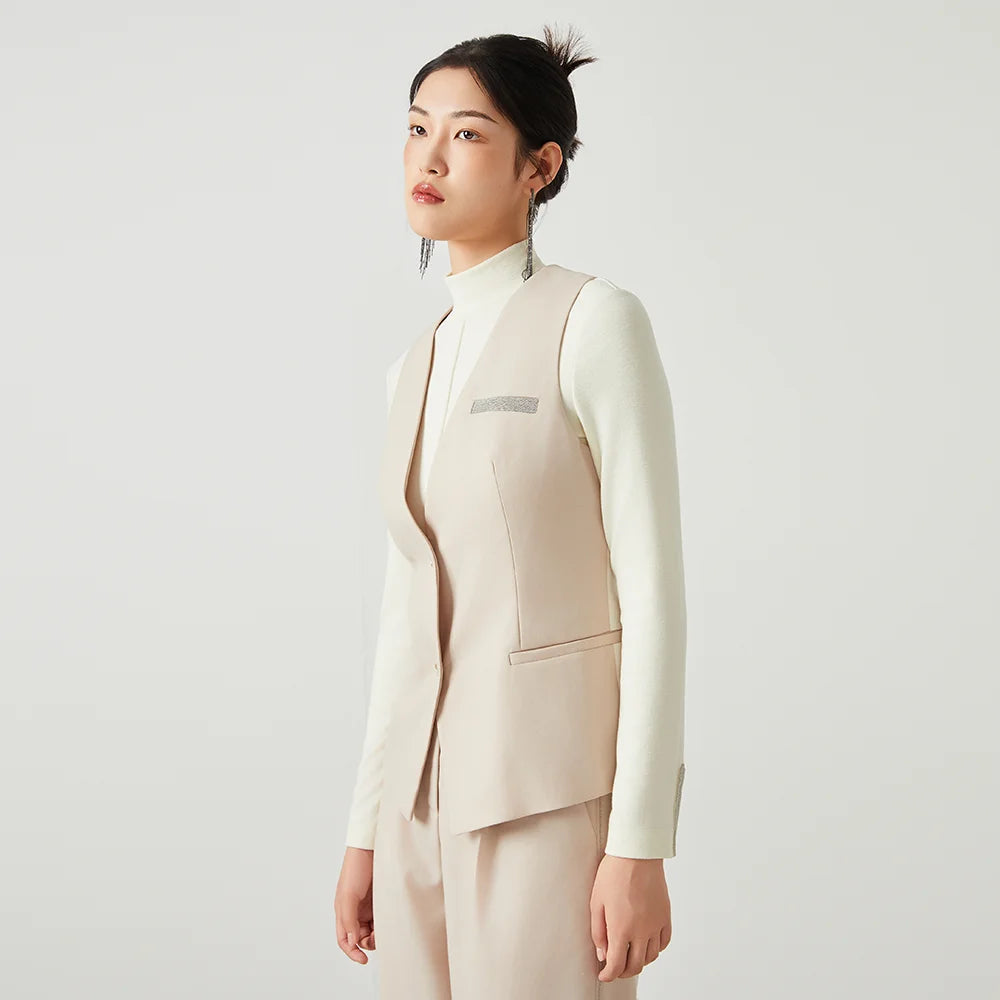 Women’s classical V-neckline vest in Silver Pink with contrast panels, welt pockets, and rhinestone fringe trim — From Borcelleclothes.