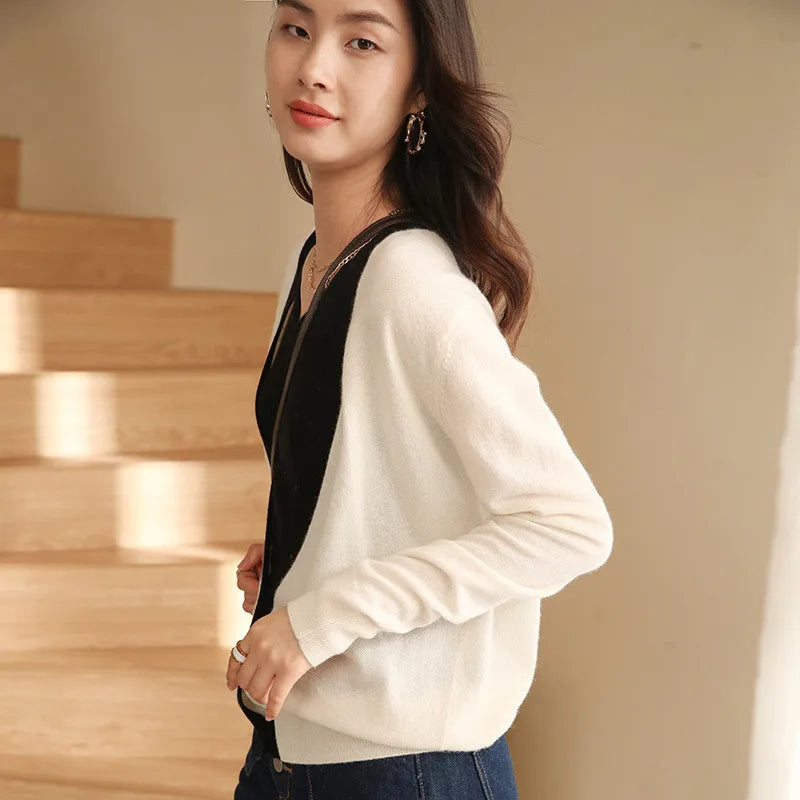 Model wearing the Pearl Bush contrast-trim cashmere cardigan, side view with dropped shoulders and elongated V-neckline. — From Borcelleclothes.
