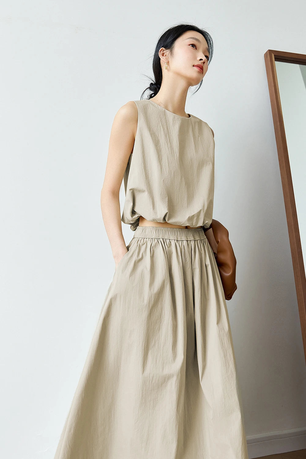 Model in Coral Reef set with hand in skirt pocket — showcasing the quilted waistband and relaxed fit. From Borcelleclothes.