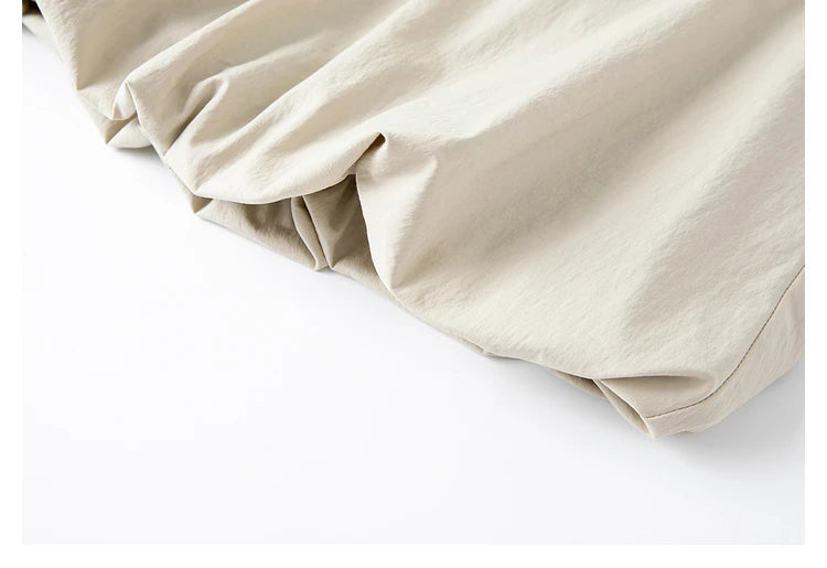 Close-up of gathered bottom hem of the top — soft volume shaped by light motion. From Borcelleclothes.