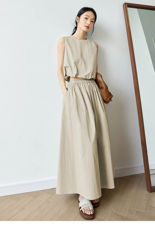Women’s two-piece set in Coral Reef color featuring a sleeveless crinkled top with a gathered hem and a flowing calf-length skirt with a quilted waistband. From Borcelleclothes.