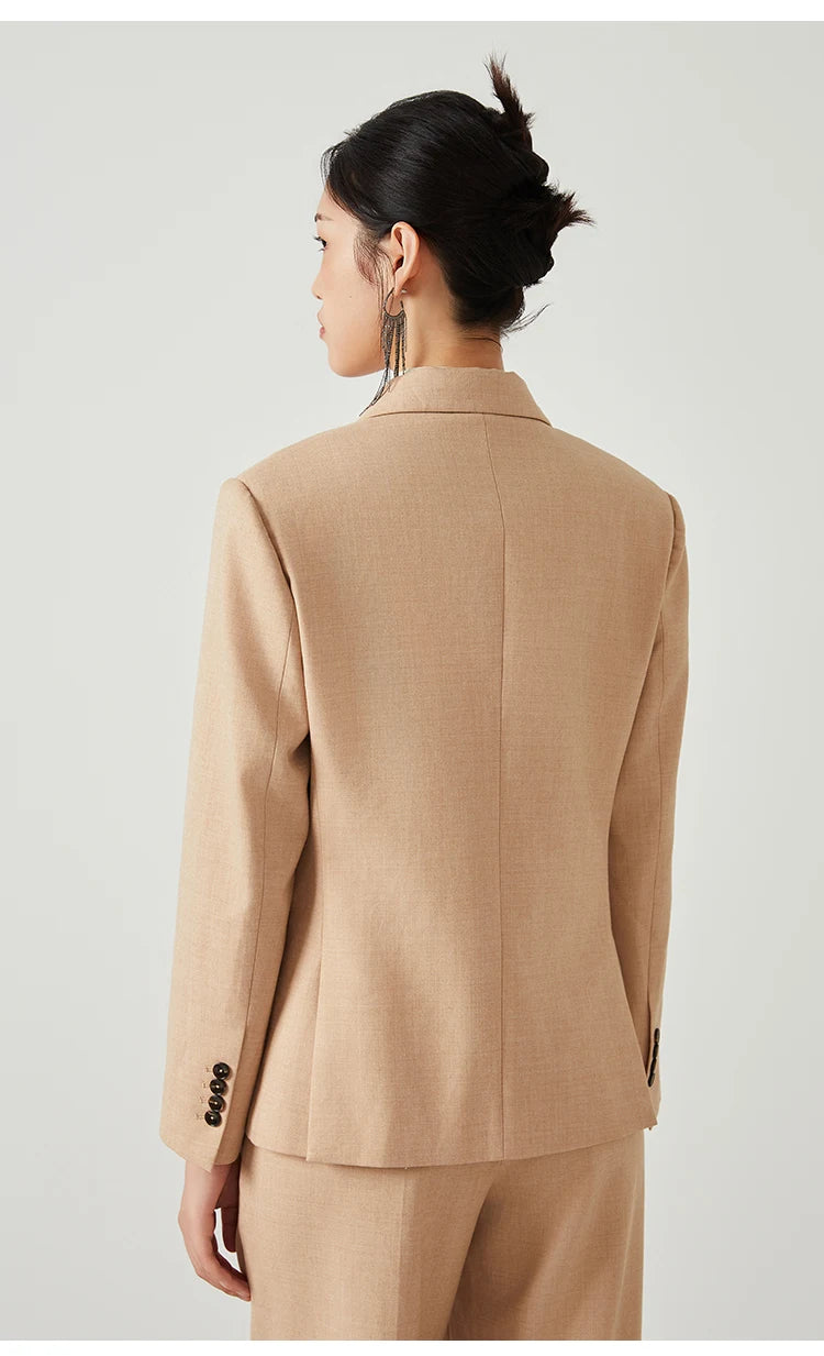 Back view of woman wearing Desert Sand blazer, showing straight cut and clean lines. From Borcelleclothes.