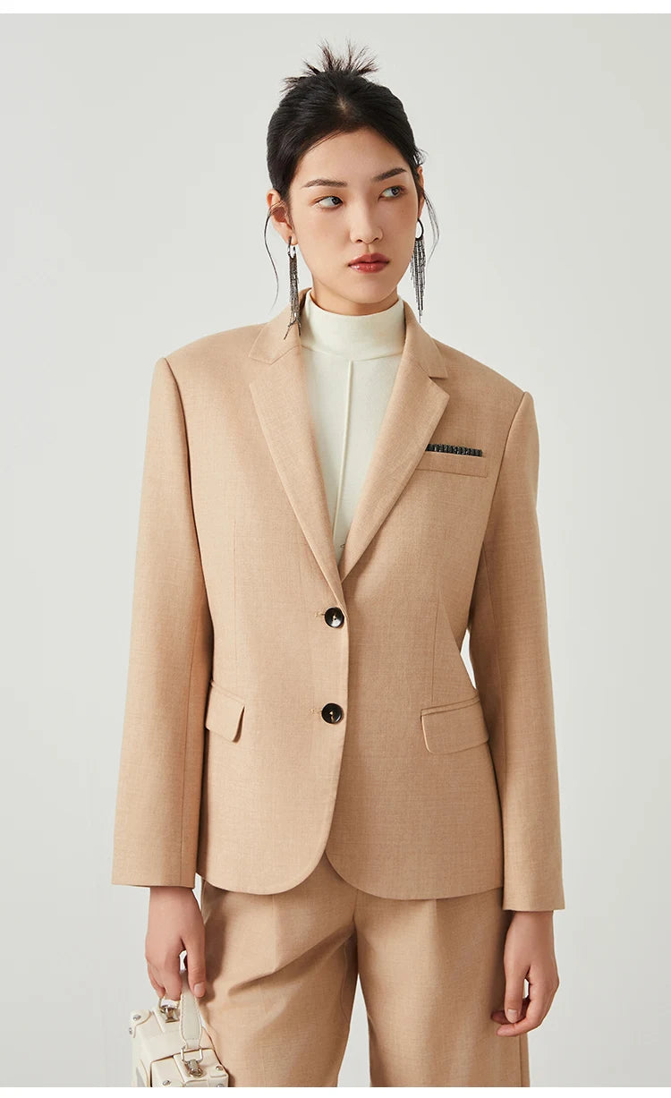 Woman in Desert Sand blazer looking to the side, highlighting chest pocket with rhinestone trim. From Borcelleclothes.